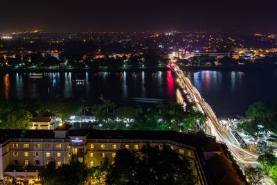 High angle view of city lit up at night