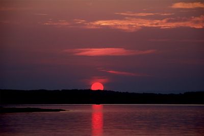Scenic view of sea against romantic sky at sunset