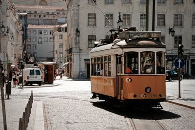 Tram moving on street in city