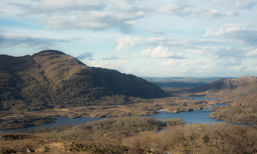 Scenic view of lake against cloudy sky