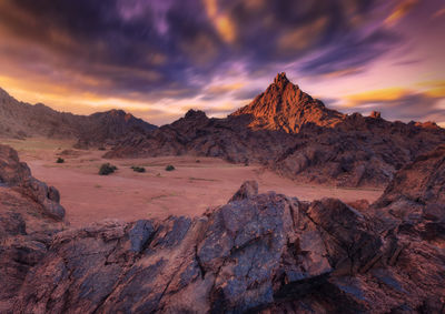 Scenic view of desert against sky during sunset