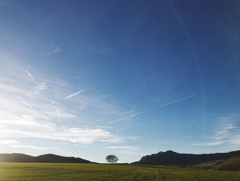 Scenic view of landscape against blue sky