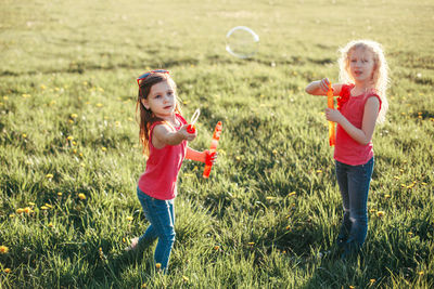 Siblings playing on field