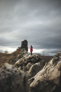 Man on rocks against sky