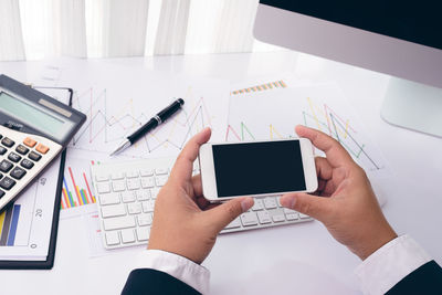 High angle view of person using smart phone on table