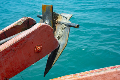 Close-up of padlocks on railing against sea