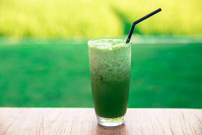 Green fresh smoothie. detox summer drink on wooden background