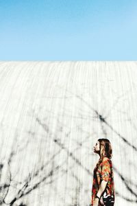 Woman standing against clear sky