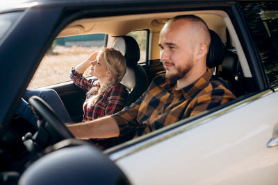 Portrait of man sitting in car