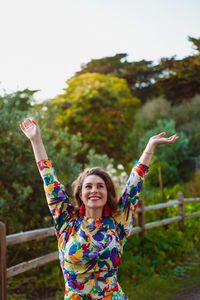 Portrait of a smiling young woman against the sky