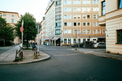 People on street amidst buildings in city