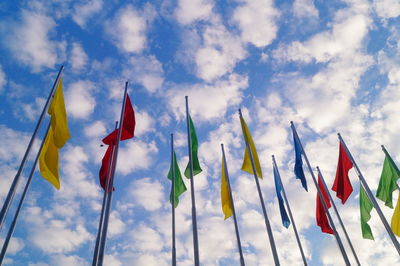 Low angle view of flags hanging against sky