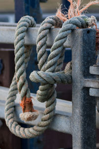 Close-up of rope tied on railing