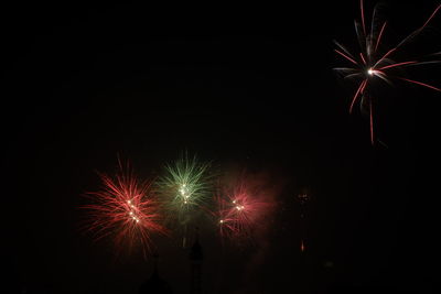 Low angle view of firework display at night