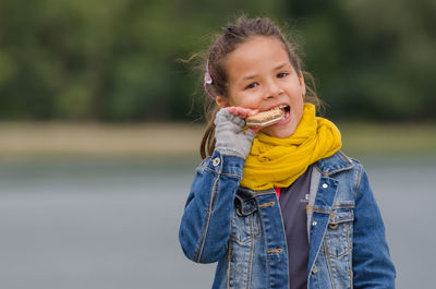 Portrait of smiling girl eating food