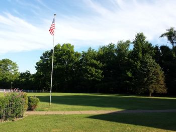 American flag against sky on field