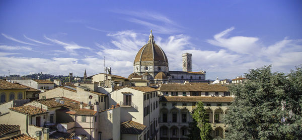 Buildings in town against sky