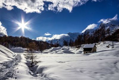 Scenic view of snow covered mountains against sky