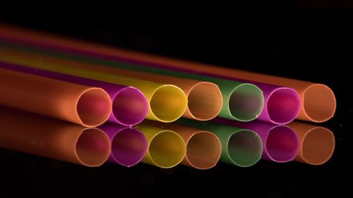 Close-up of colorful balloons against black background
