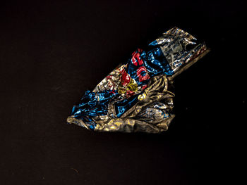 High angle view of multi colored umbrella on table against black background