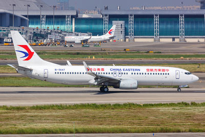 Airplane on airport runway against sky