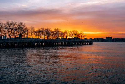 Scenic view of river against orange sky