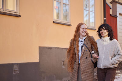 Smiling young women walking in street