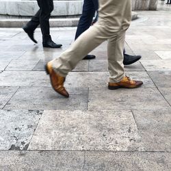 Low section of people walking on street