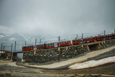 Railway and train in cloudy gornergrat mountains. zermatt, swiss alps. adventure in switzerland.