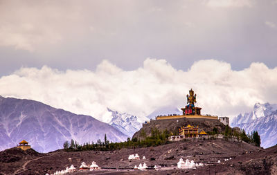 Panoramic view of building against cloudy sky