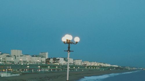 View of illuminated street light against blue sky