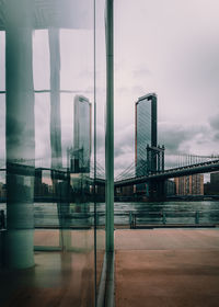 View of city against sky seen through glass window