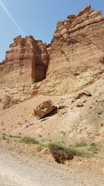 Rock formations on landscape against sky