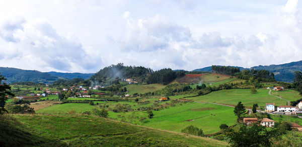 Scenic view of landscape against cloudy sky