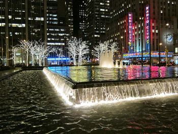 Illuminated buildings in city at night