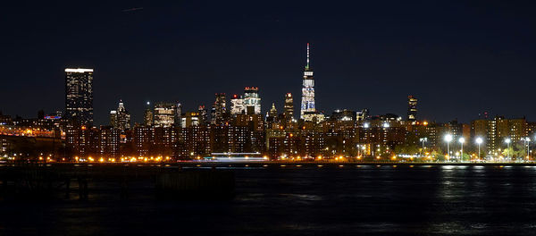 Illuminated buildings against sky at night