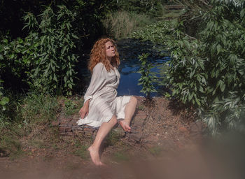 Woman sitting in front of the lake