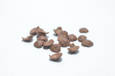 Close-up of coffee beans against white background
