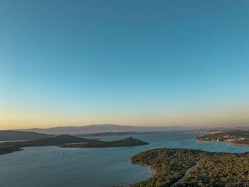 Scenic view of sea against clear sky at sunset