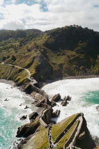 High angle view of sea by footbridge