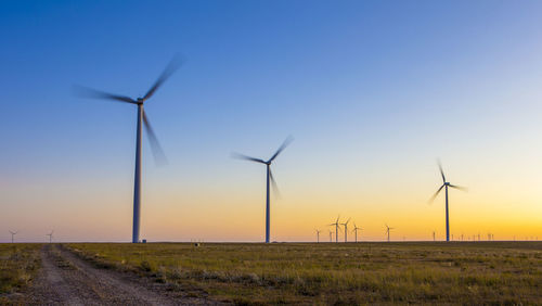 Colorado wind farm located on a wheat field during sunset