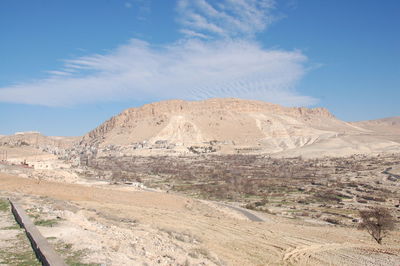 Scenic view of desert against blue sky