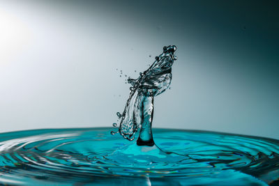 Close-up of water splashing against blue background
