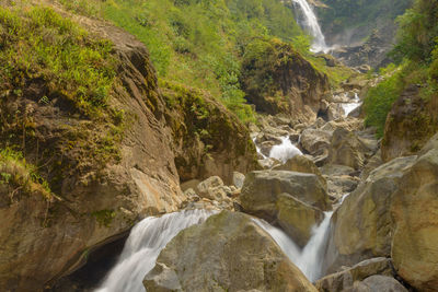 Scenic view of waterfall amidst rocks