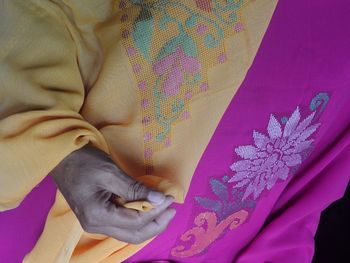 Midsection of woman wearing karawo cloth, a traditional cloth of gorontalo, indonesia.