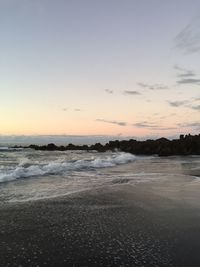 Scenic view of beach against sky during sunset