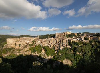 Panoramic view of trees and buildings against sky