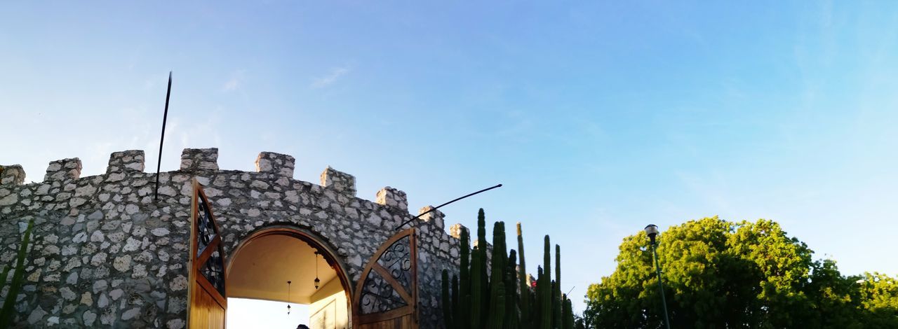 architecture, built structure, sky, building exterior, low angle view, building, nature, tree, plant, no people, city, blue, day, outdoors, tower, travel, street light, travel destinations, cloud - sky