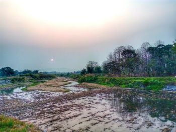 Scenic view of river against sky during sunset