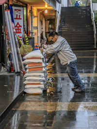 Man on wet street in city during monsoon